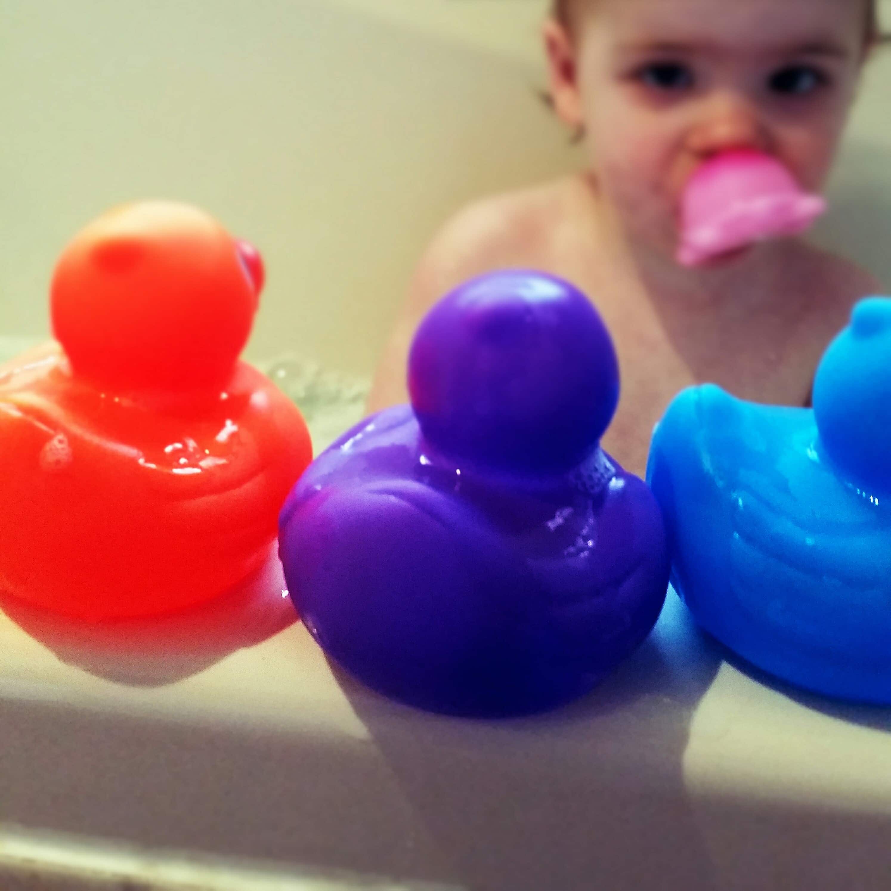 Bath Ducks with baby in the background