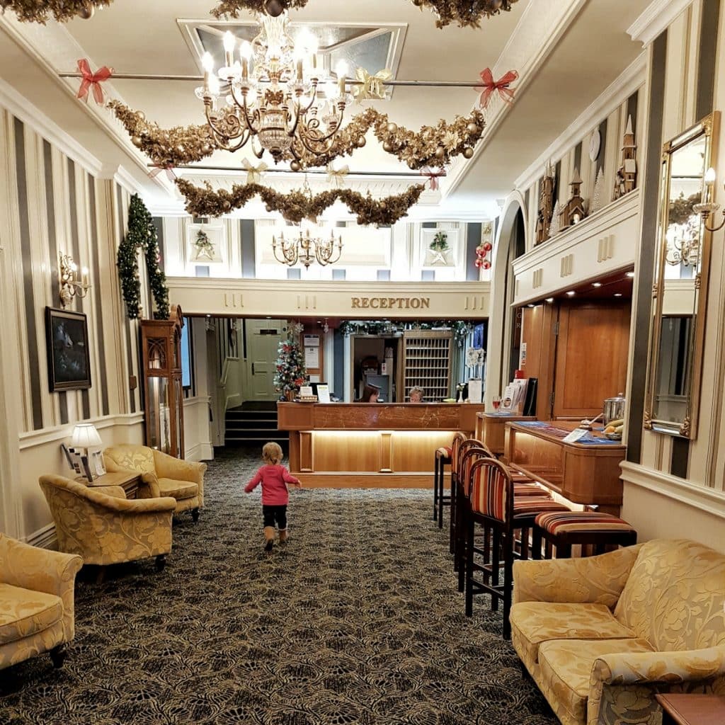 Little girl running through lobby of the Langstone Cliff hotel