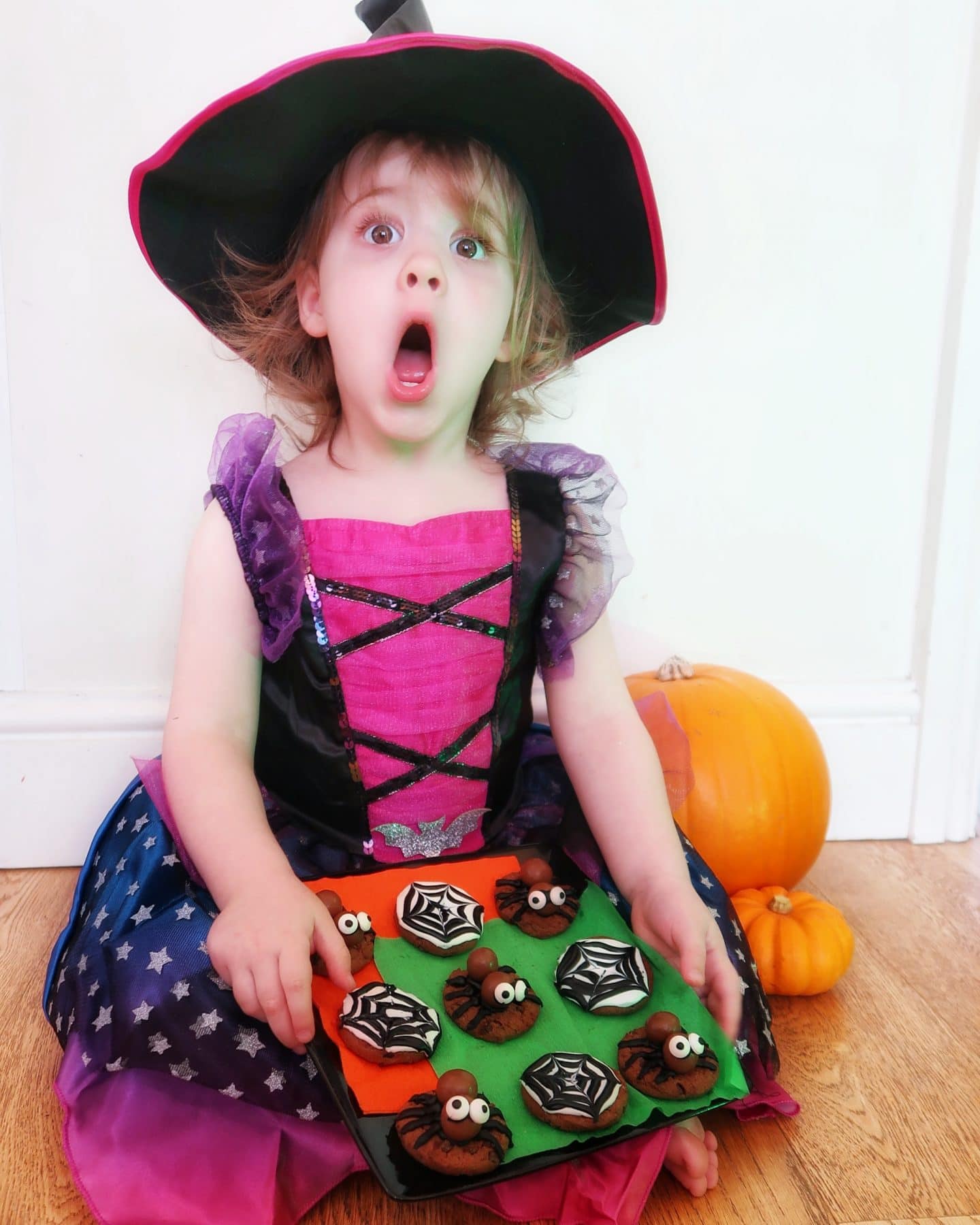 A Halloween witch with Halloween cookies