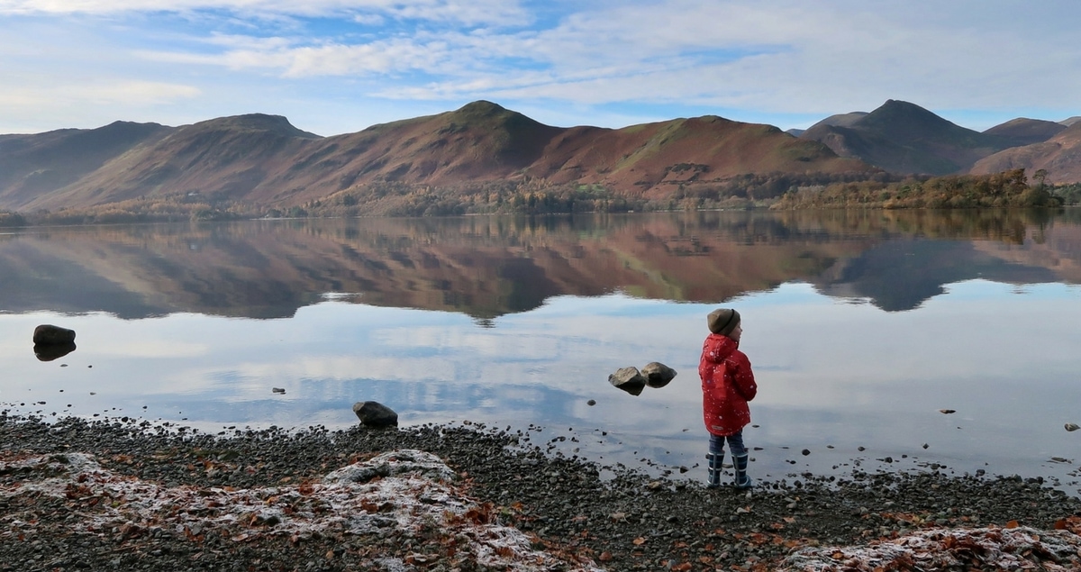 Schrödinger's Autism - a boy stands by a frosty lake with mountains in the distance.