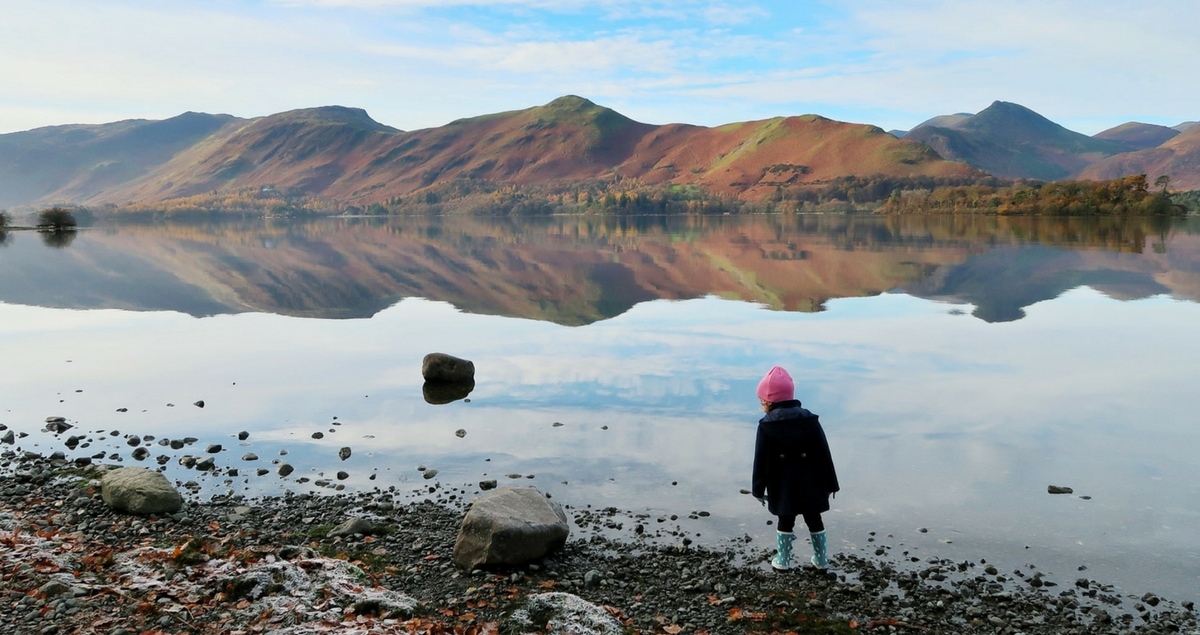 On the Street Where You Live - little girl by a lake with mountains in the distance.