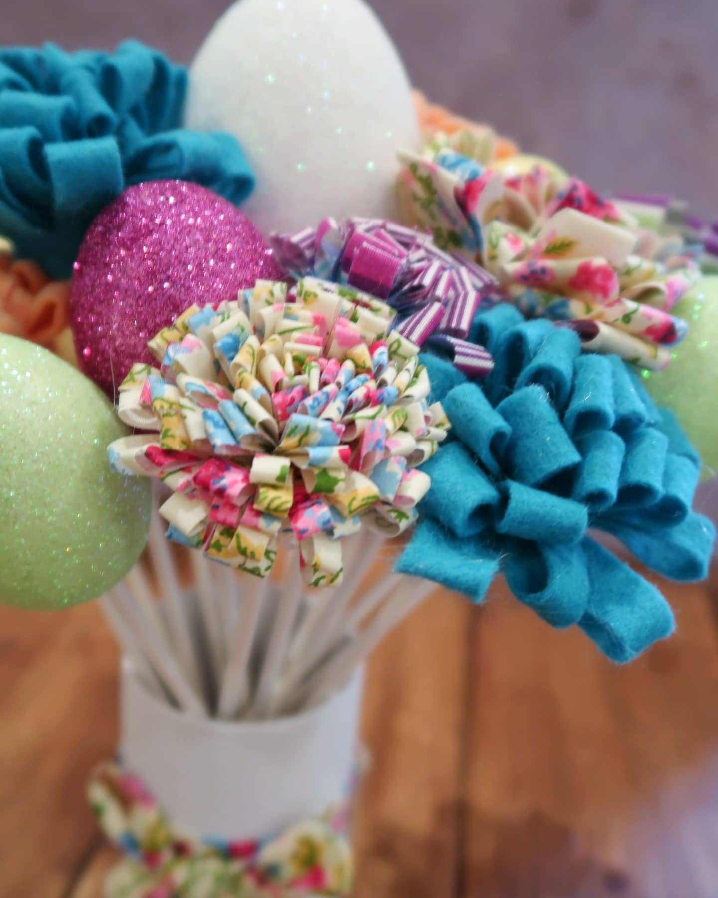 Easter decoration with fabric flowers and glittery eggs