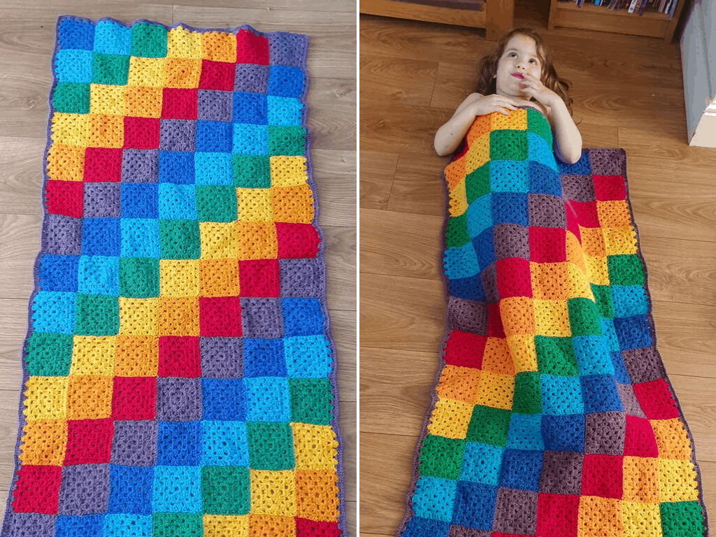 Small girl with rainbow crochet blanket