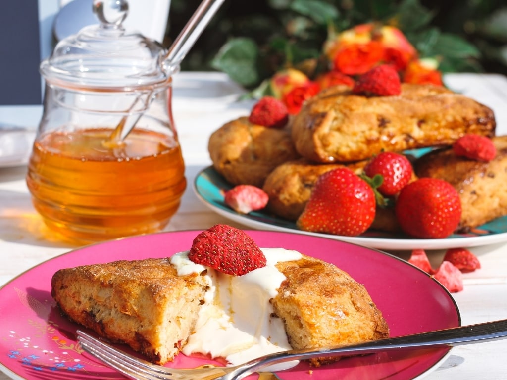 Close up of Stawberry scones with honey pot