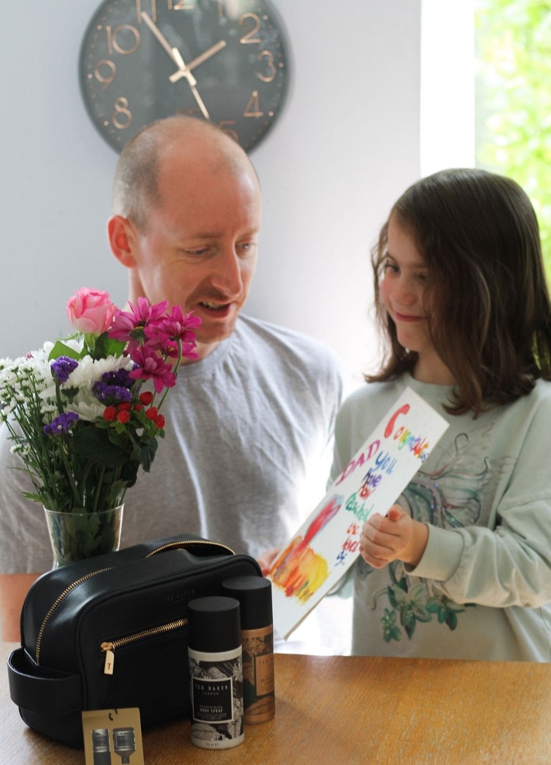 Girl with Father giving Father's Day card and gifts