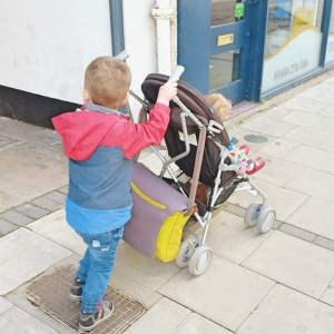 Biggest pushing Littlest in the buggy